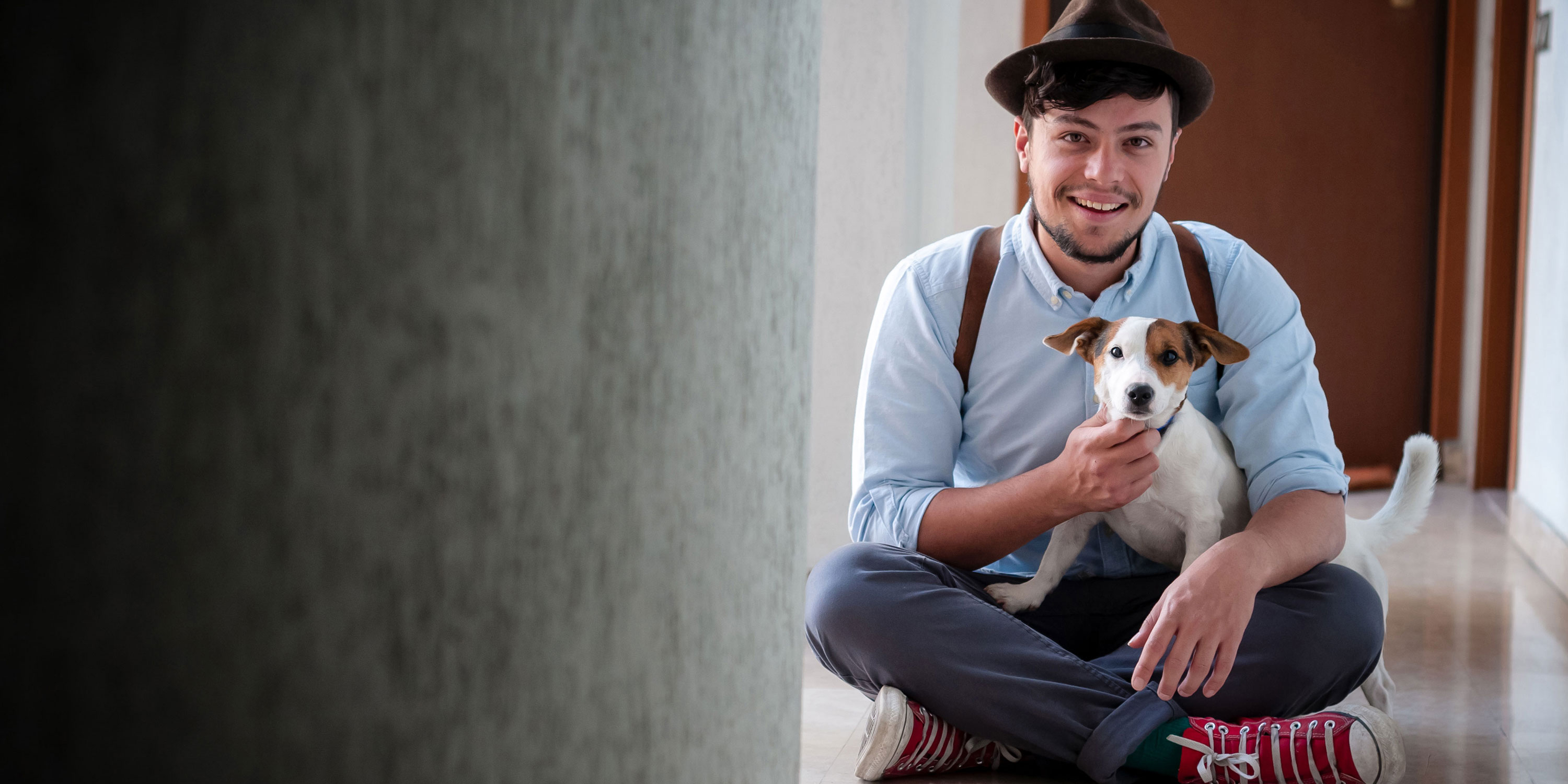 hipster young man posing with jack russell dog